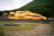 A big lying buddha outside a hotel on Esan
